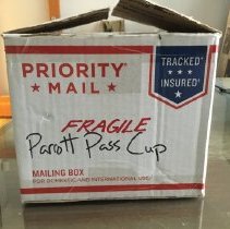 Rectangle USPS Box Labeled 'Parrott Pass Cup' Containing a Cannonball